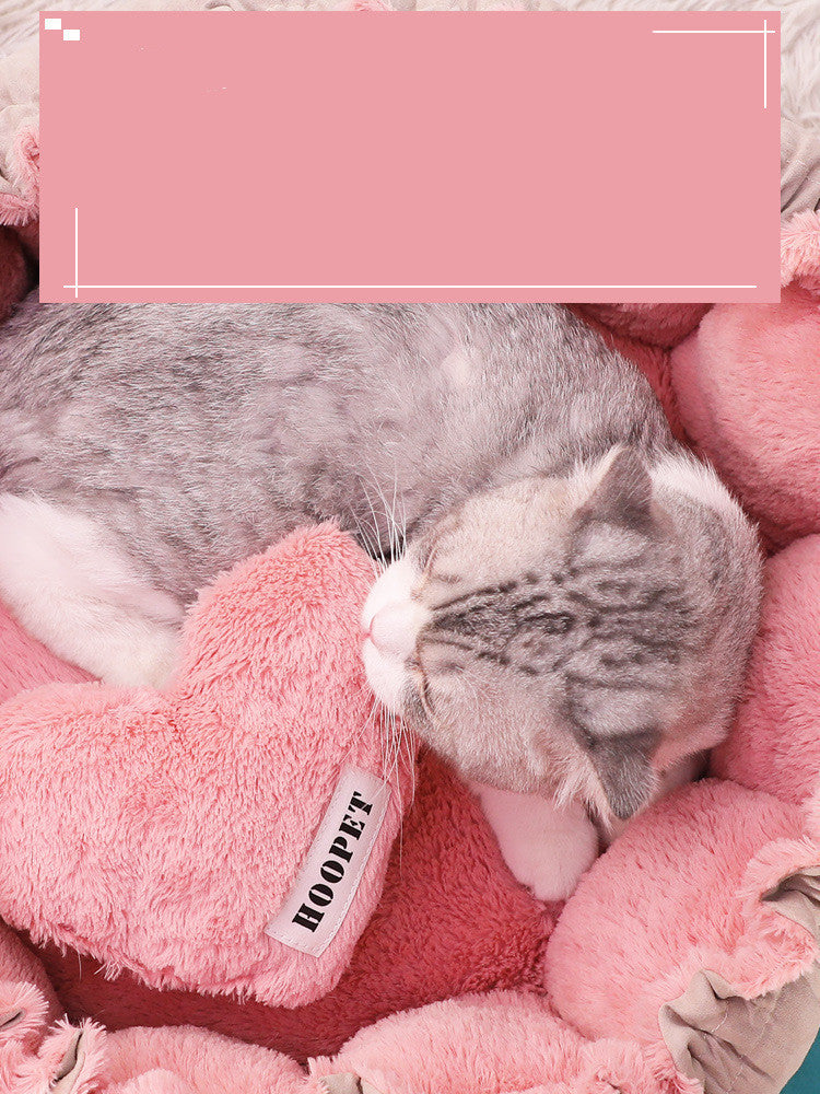 Close up of cat snuggled in pink cat bed