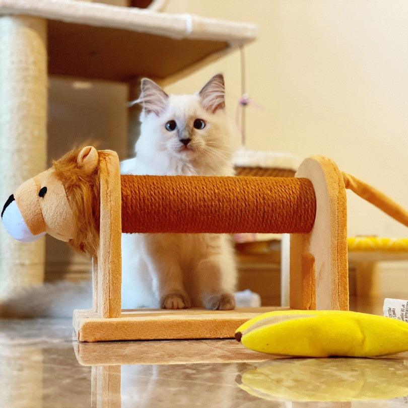 Cat playing with a lion-shaped scratching post on a wooden floor.