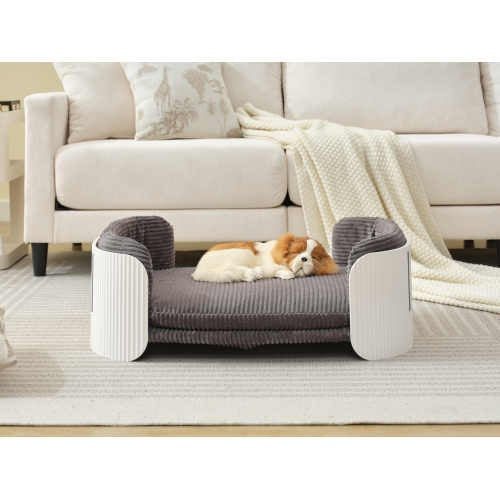 white and brown dog sleeping in scandanavian style gray dog bed