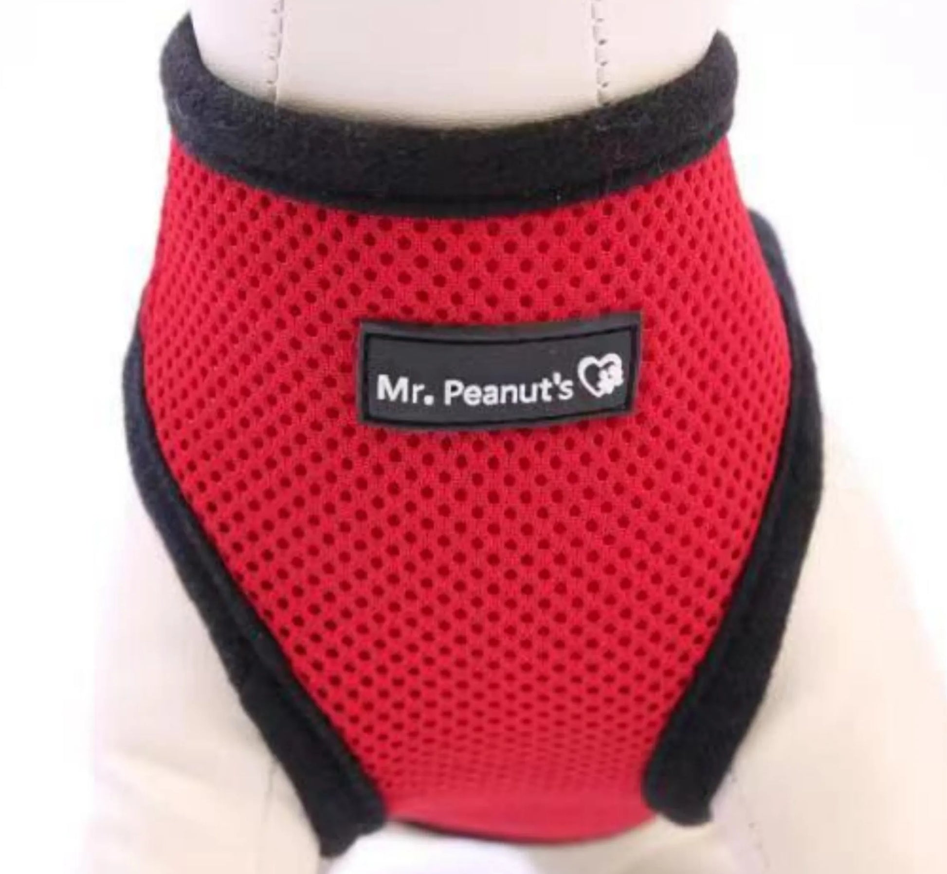 Red pet harness with black trim and 'Mr. Peanut's' label on a white background