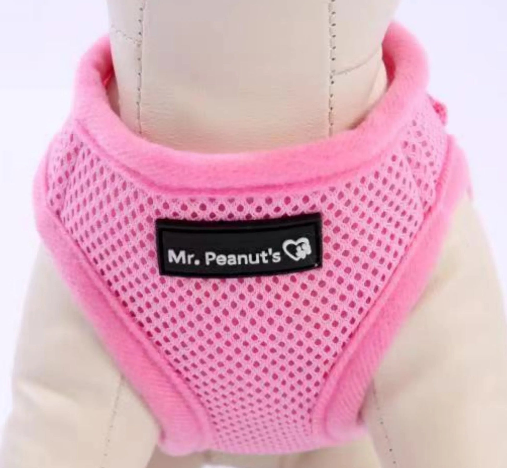 Pink dog harness with 'Mr. Peanut's' label on a white background