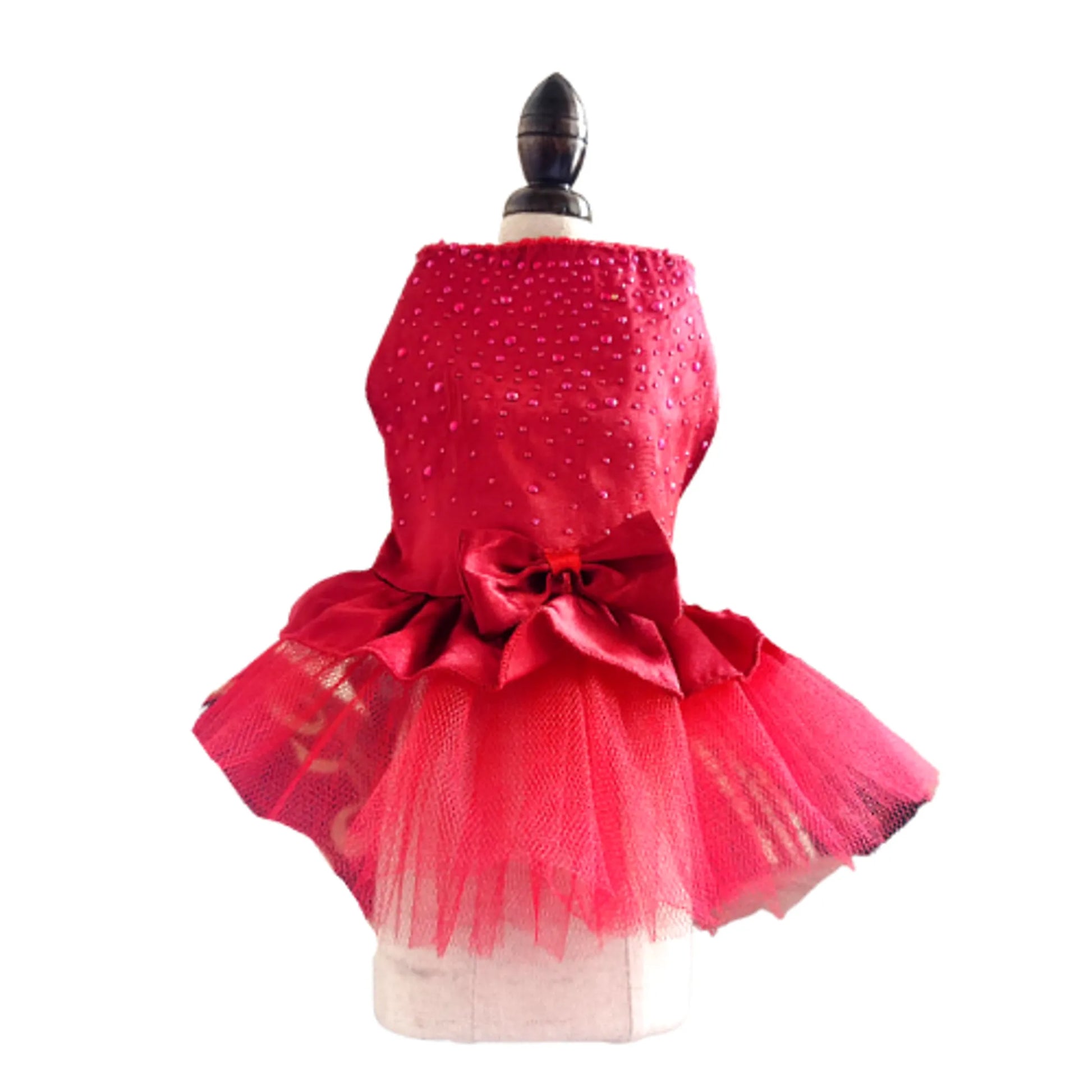 Red polka dot dress with a large bow on a mannequin against a white background