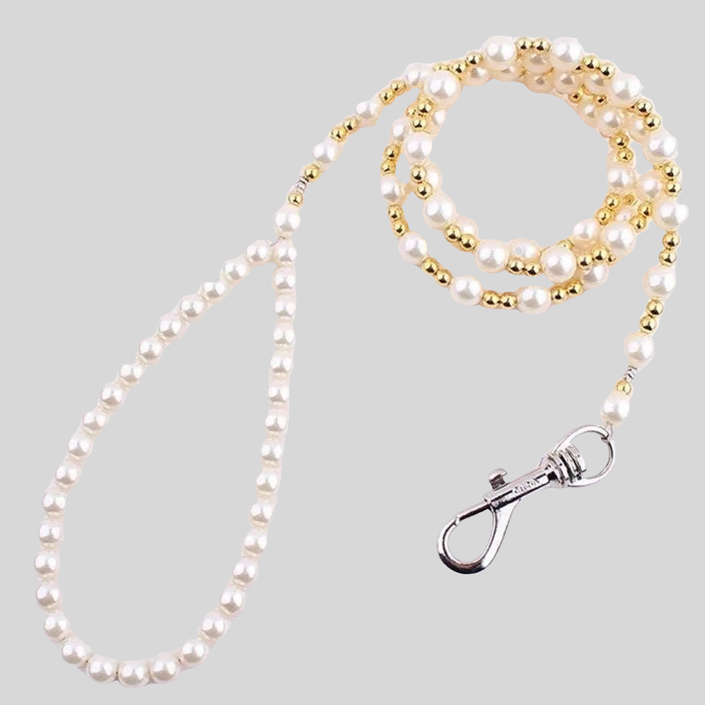 Pearl and gold beaded lanyard with a metal clasp on a light gray background